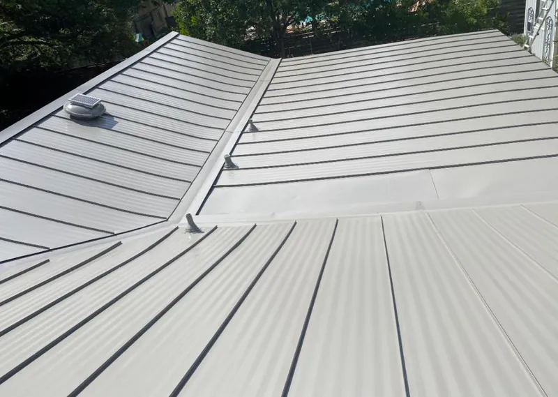 Solar attic fan installed on a metal roof for Roof Ventilation in West Miami